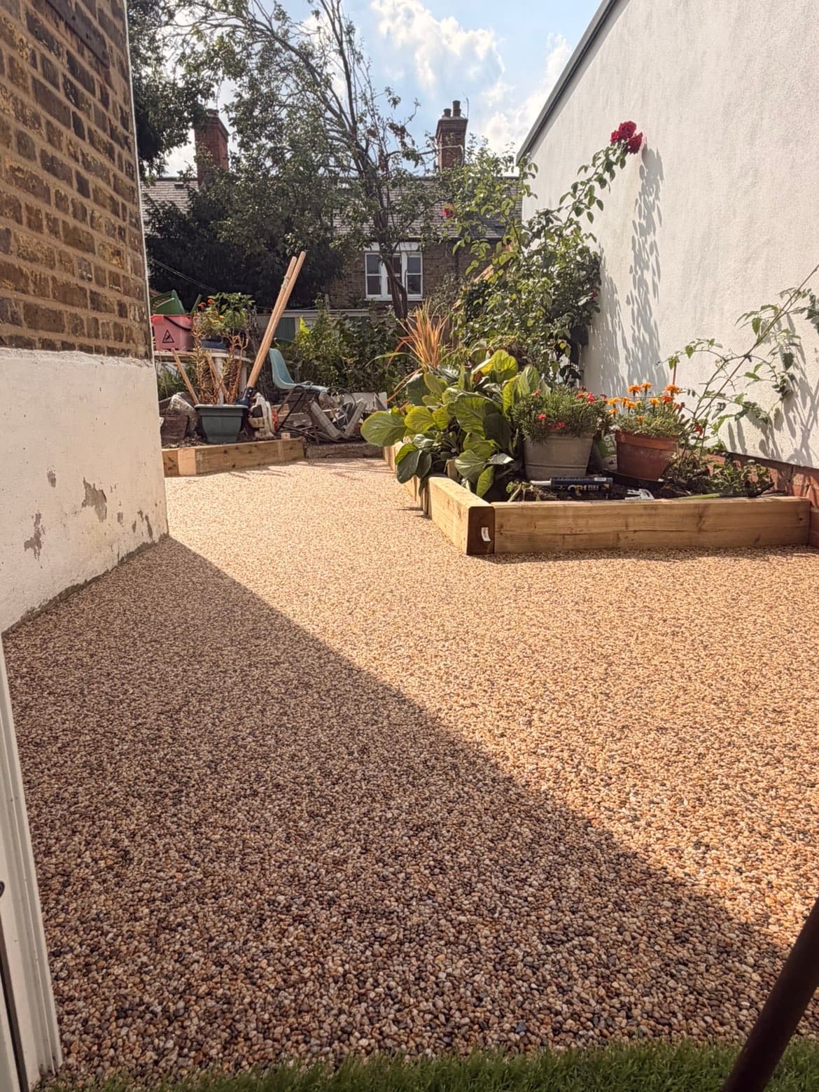 Timber sleeper raised beds we built alongside a resin bound surface in a landscaped garden