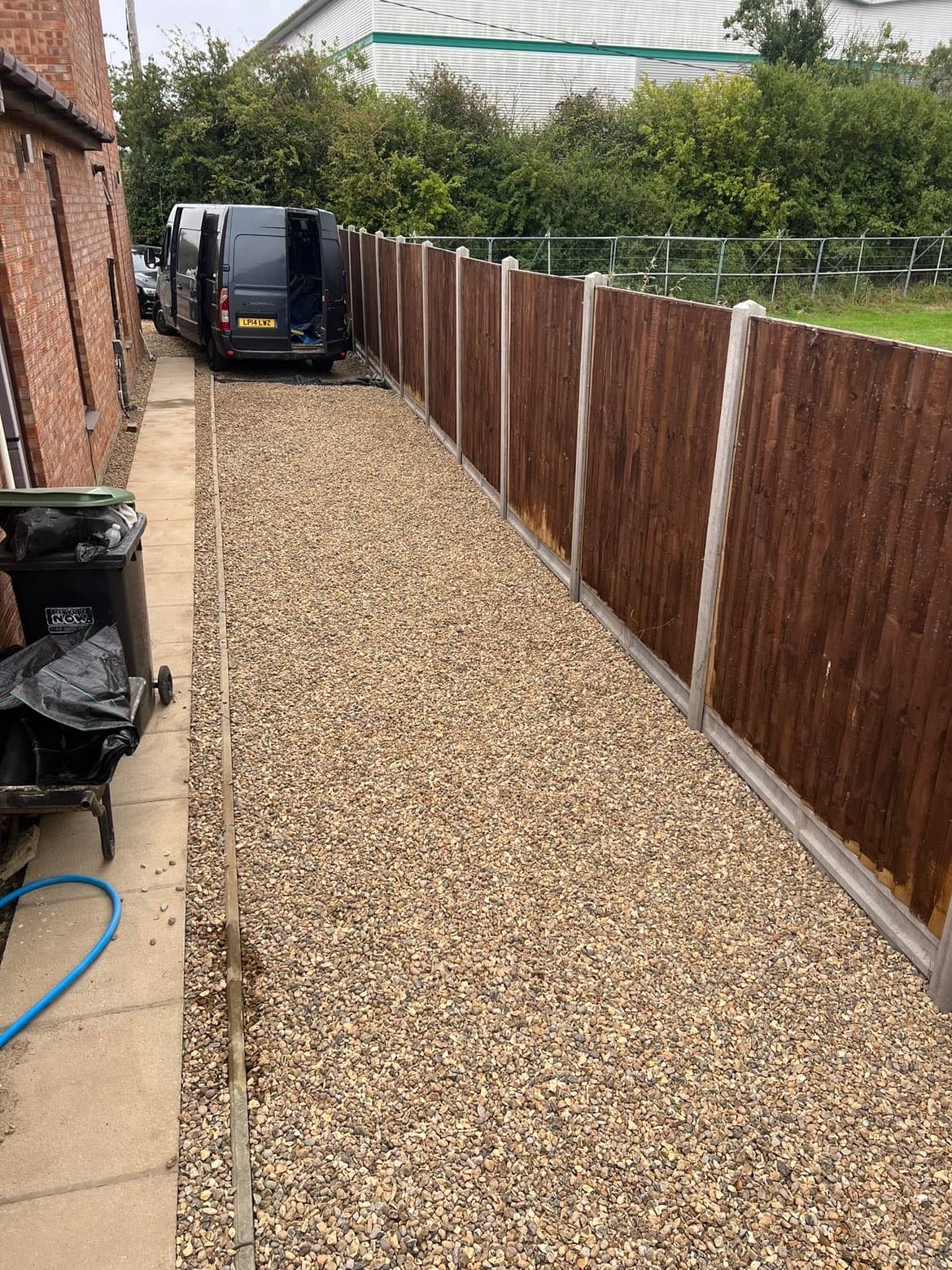 Finished side access with neat gravel surface and timber fencing