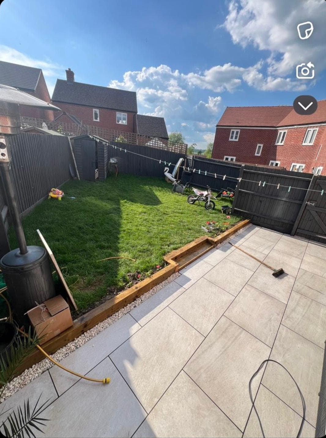 Completed garden with porcelain patio, timber sleepers and fresh lawn