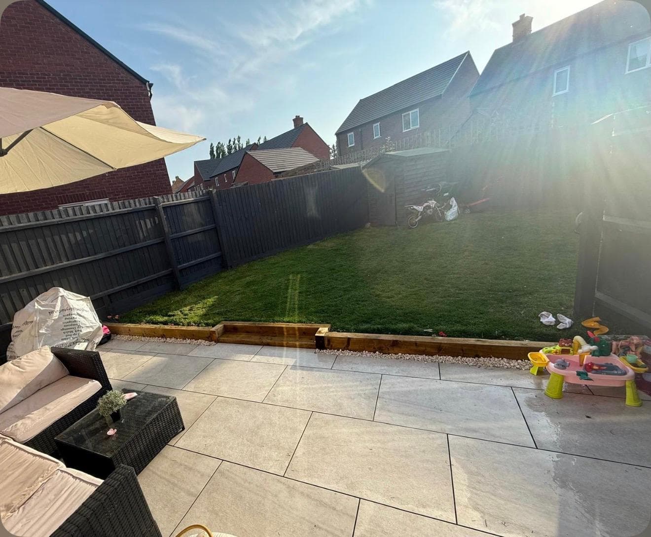 Another view of finished patio with outdoor furniture and umbrella