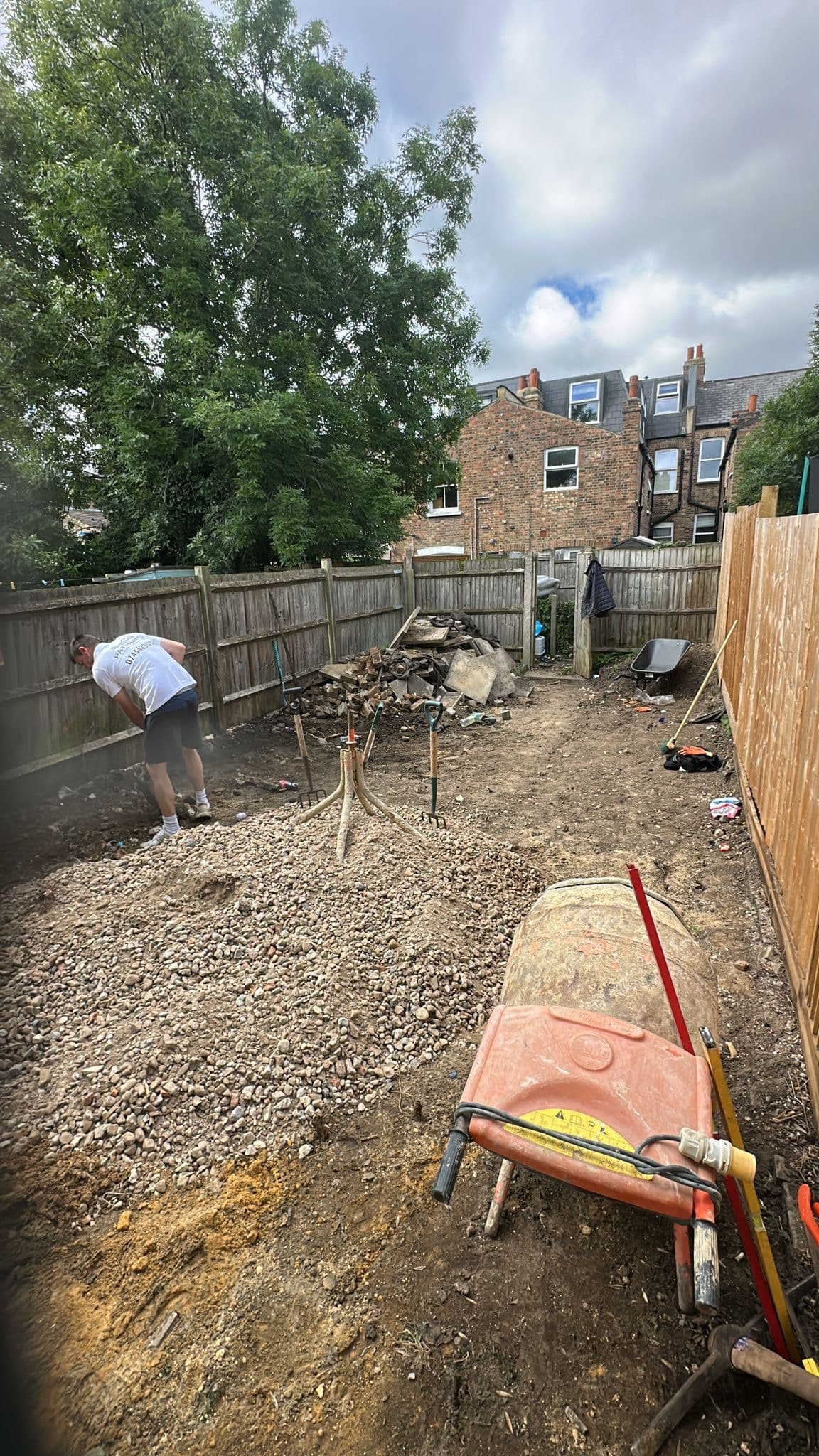 Garden being excavated and prepared with a compacted hardcore sub-base before laying Kandla grey Indian sandstone